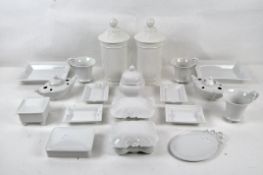 A mixed group of white glazed porcelains including lidded vessels, cups, and more, by Kaiser,