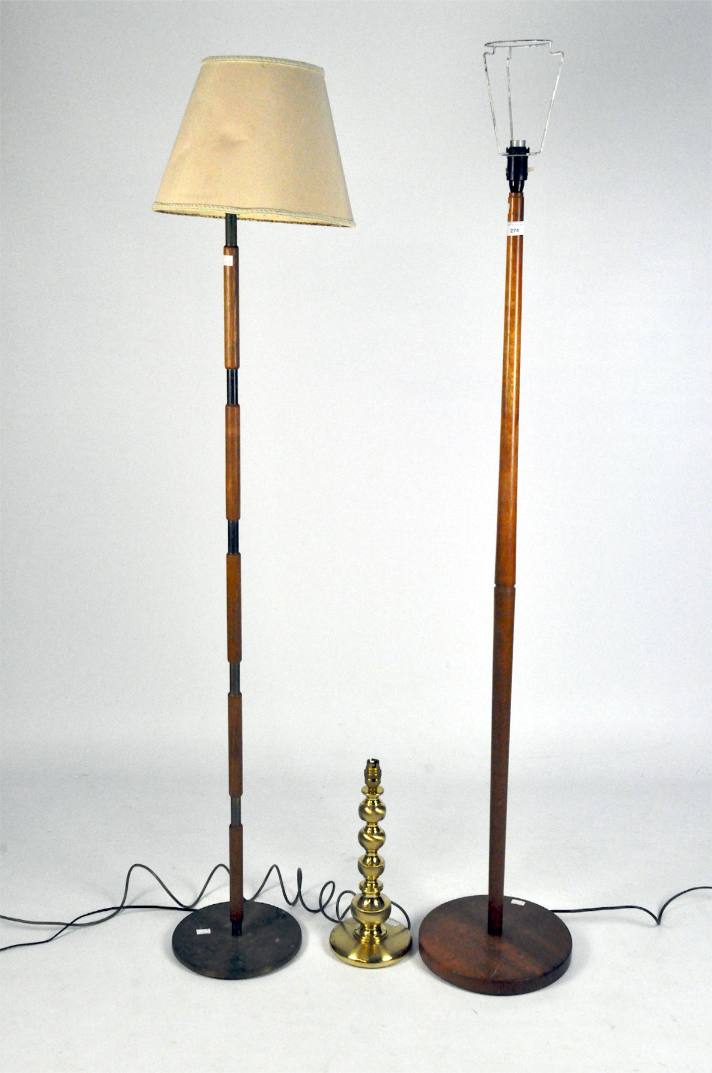 A vintage brass table lamp, 38cm high, together with two wooden standard lamps,