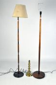 A vintage brass table lamp, 38cm high, together with two wooden standard lamps,