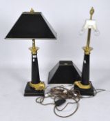 A pair of 20th century black and gilt table lamps with gilt flame tops and matching square shades,