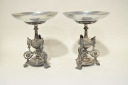 A pair of Victorian silver plated stands, in the classical design with tripod bases,