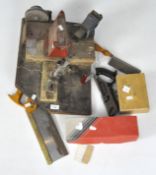 A quantity of tools, including a plane, a vice, a saw,
