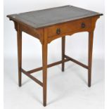 An early 20th Century leather topped oak desk, with gilt tooled detailing to the top,