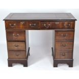 A modern twin pedestal desk, the top with gilt tooled leather writing surface,