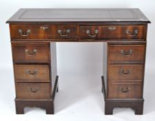 A modern twin pedestal desk, the top with gilt tooled leather writing surface,