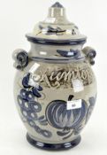 A German lidded pot marked 'Rumtopf', glazed in grey and blue,