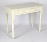 A white painted pine side table, with two single drawers to the front, raised upon turned supports,