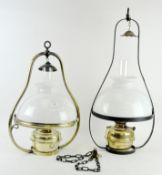 Two 20th Century oil ceiling lamps, ceramic shades and flutes supported by metal frames,