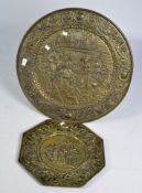 Two brass chargers, of circular and octagonal form, with Teniers style scenes in high relief,