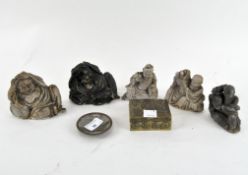 A selection of Chinese soapstone and plaster figures depicting Buddha, in recumbent poses,