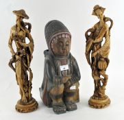 Two 20th century oriental figures, resin, of a male and female with a wooden figure of a child