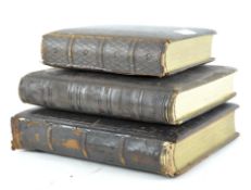 Three 19th Century leather bound postcard albums, each with gilt tooled decoration,