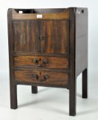 A Georgian mahogany pot cupboard, with double doors above pull-oout cupboard, on square legs,
