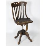 A late 19th/early 20th century oak captain's chair, with buttoned leather seat,