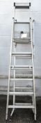 Two step ladders, each with six treads, and a three-way domestic combination ladder,