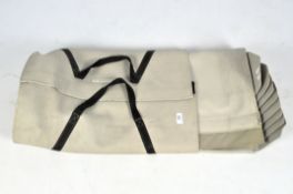 A beige set of folding aeroplane steps in a bag