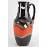 A West German pouring vessel glazed in brown and orange,