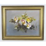 A contemporary oil on board depicting a floral still life, indistinctly signed,