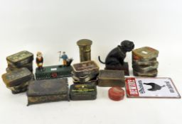 Three vintage cast metal money boxes with a selection of vintage cigarette and brass tins and boxes