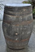 A large cooppered wooden barrel,