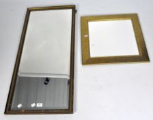 A large gilt framed bevelled edge mirror together with a another smaller wall mirror