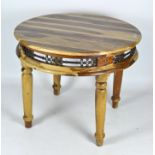 A contemporary round wooden table, with pierced metalware frieze, on turned baluster legs,