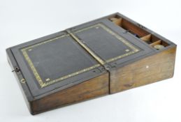 A mahogany and brass bound writing slope with fitted interior and black leather inset,