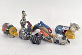 A collection of South African RAKU Studio pottery animals in various colours,