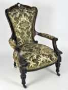 A 19th Century carved mahogany arm chair with wood framed back,