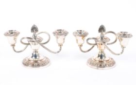A pair of silver-plated twin-light candelabra, 20th century, with reeded whiplash branches,