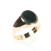 A 9ct gold signet ring, set with oval bloodstone panel. 5.5g. Size V.