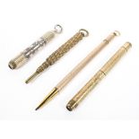 Four yellow and white metal propelling pencils, two with engine turned decoration to the handles,