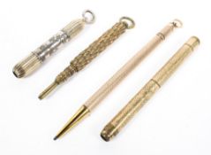 Four yellow and white metal propelling pencils, two with engine turned decoration to the handles,