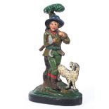 An cast metal painted doorstop of a woodsman and his dog.