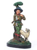 An cast metal painted doorstop of a woodsman and his dog.