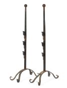 A pair of large Arts and Crafts style wrought iron fire dogs,