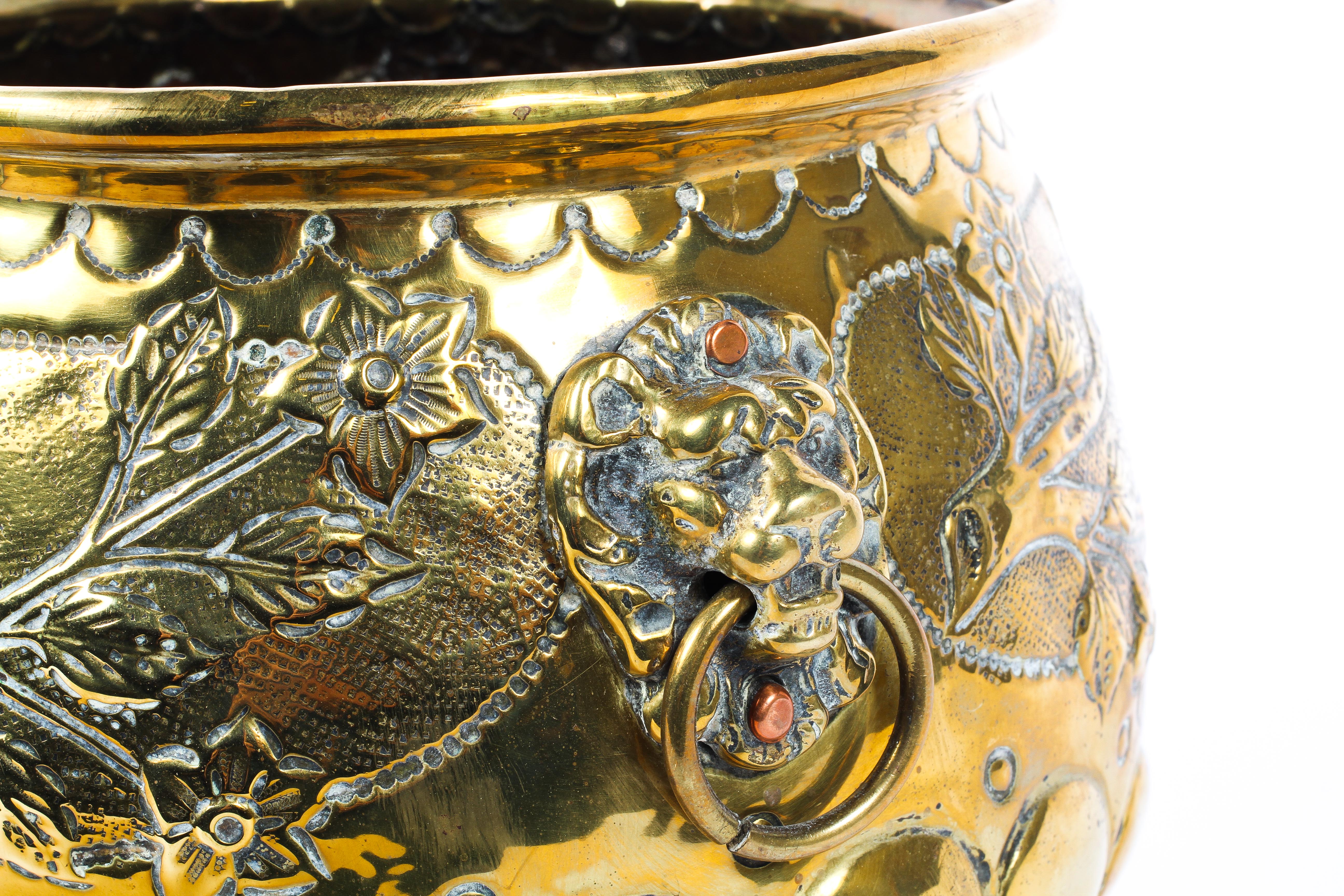 A Dutch brass footed planter, with lion masks, cast with birds amongst branches, on paw feet, - Image 3 of 4