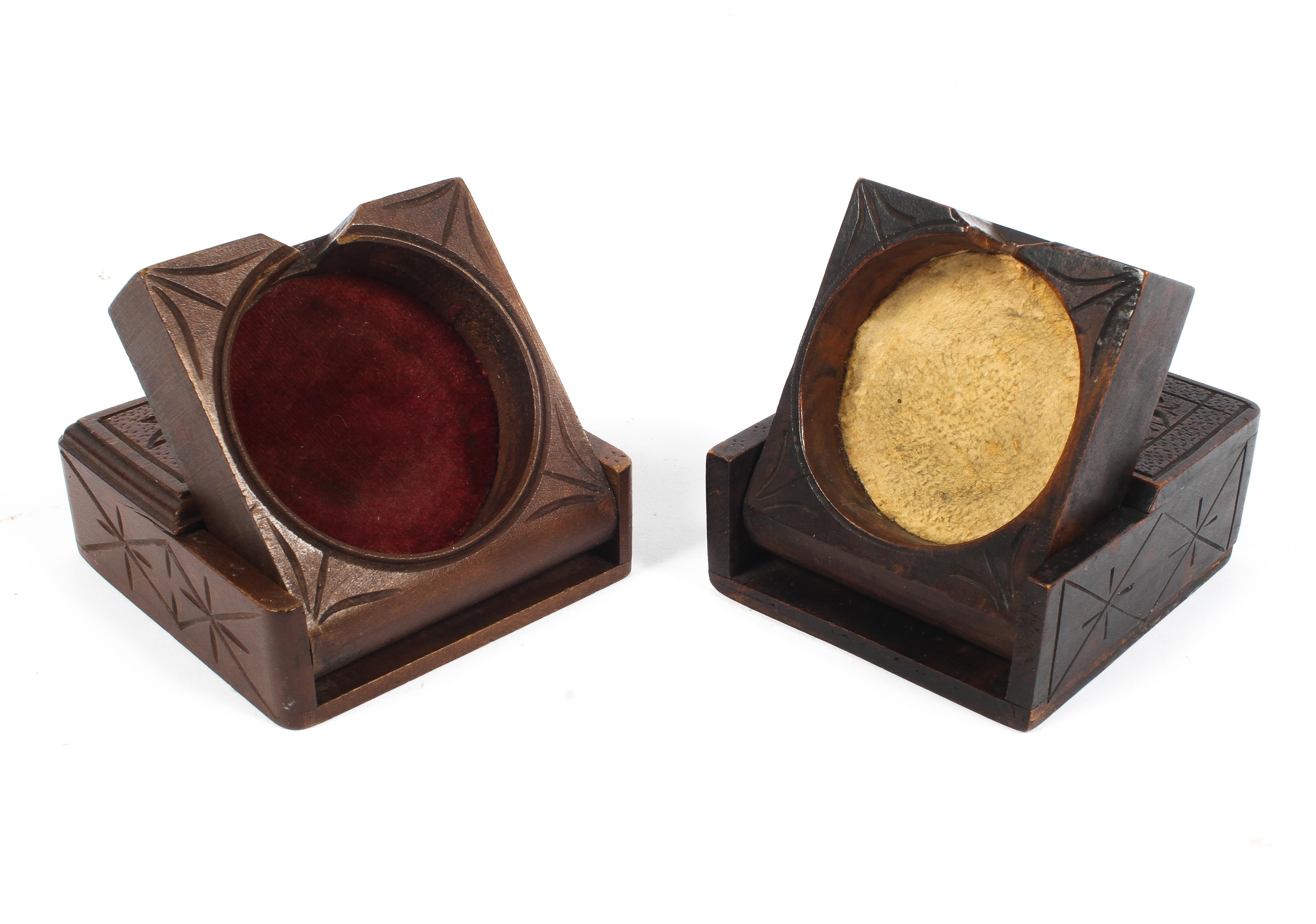 Two early 20th century carved wooden pocket watch stands, one carved "Davos",