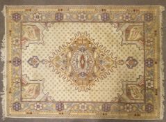 An Oriental style wool rug, cream ground with central geometric medallion,