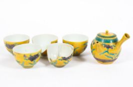 Five 19th/20th Chinese tea bowls decorated with flowering plants together with a small teapot