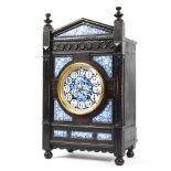 A Victorian Aesthetic Movement ebonised and enamelled striking mantle clock,