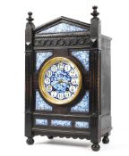 A Victorian Aesthetic Movement ebonised and enamelled striking mantle clock,