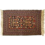 A Persian style wool rug red and cream ground with central geometric panel and geometric borders,