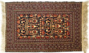 A Persian style wool rug red and cream ground with central geometric panel and geometric borders,