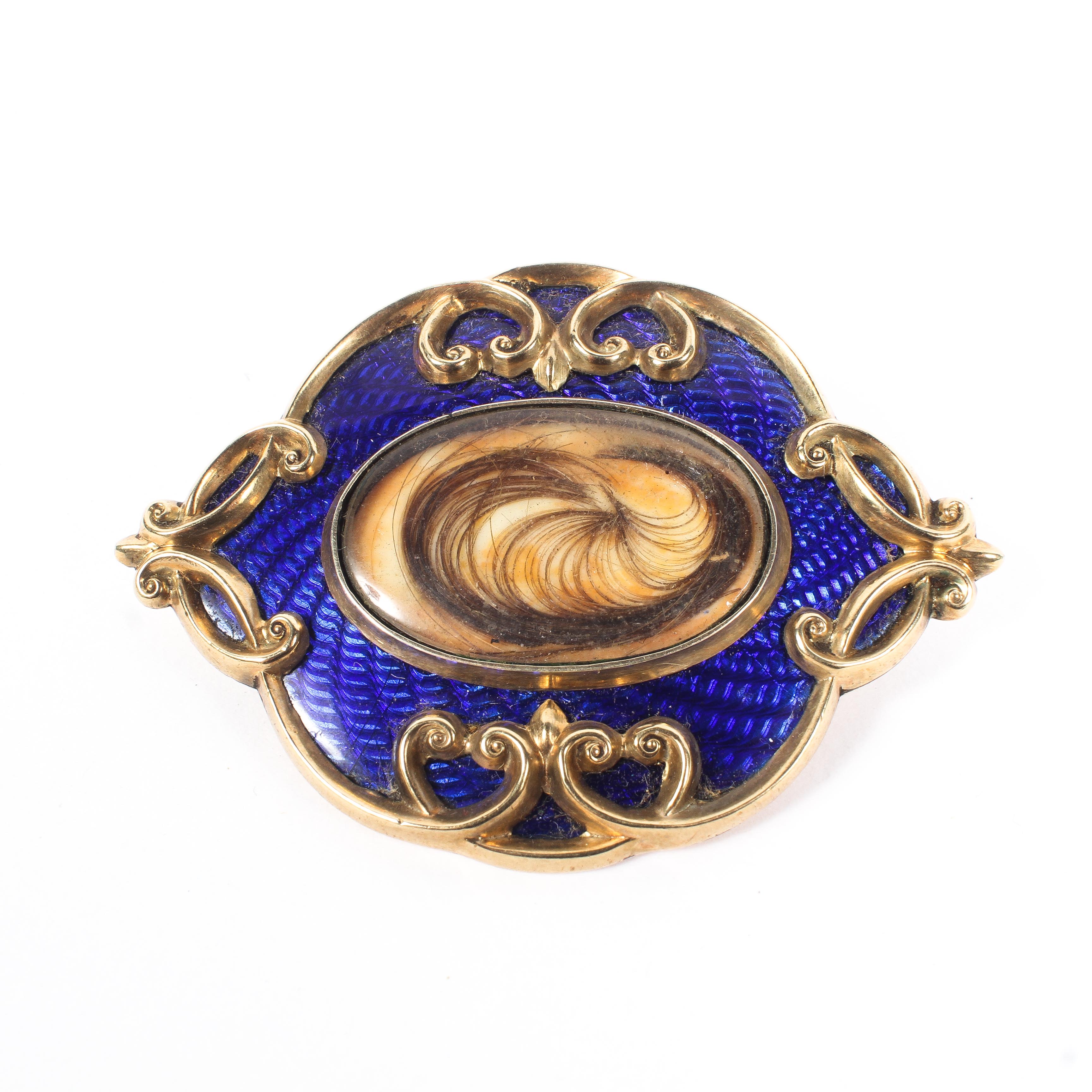 An enamel and yellow metal mourning brooch.