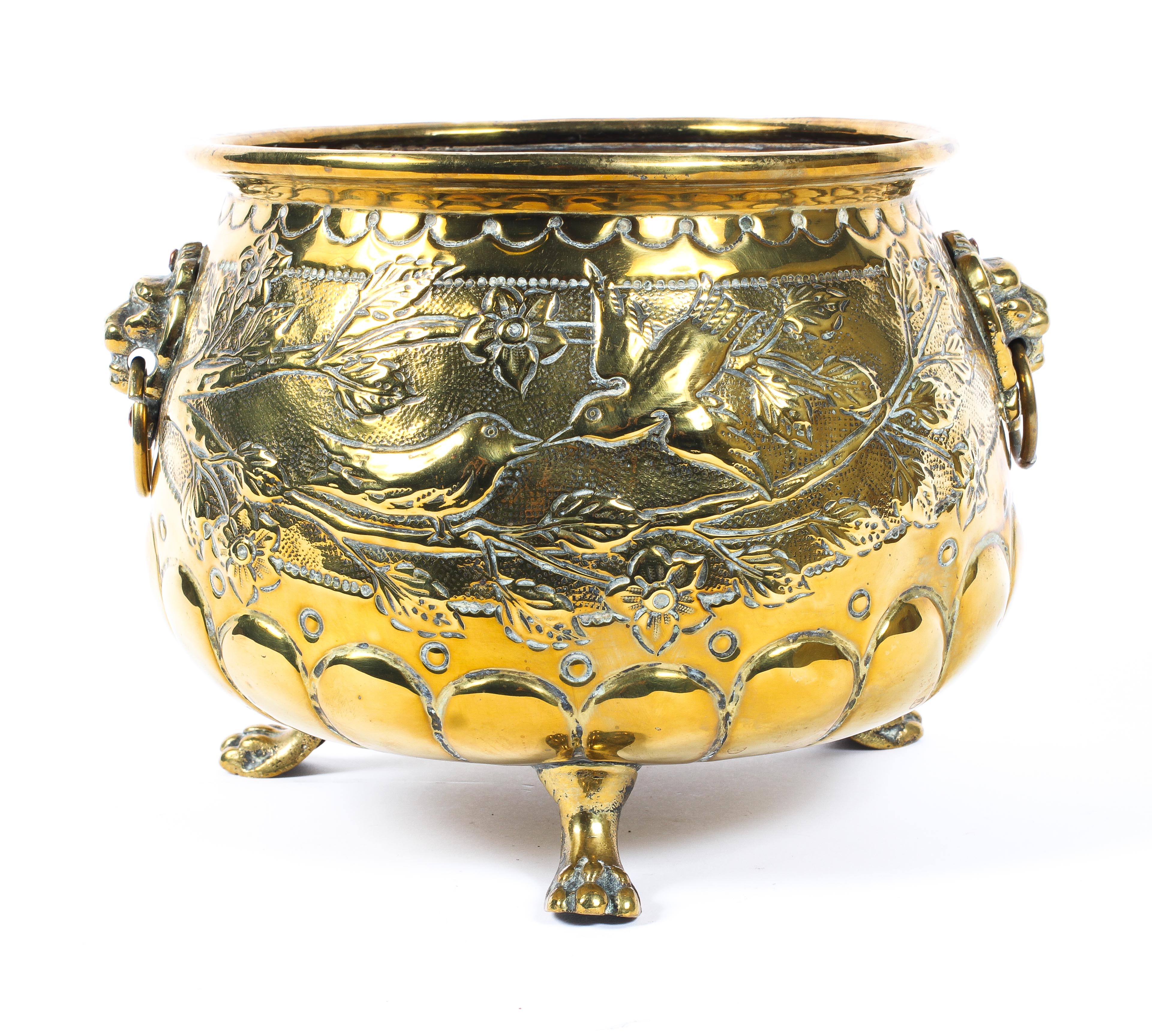 A Dutch brass footed planter, with lion masks, cast with birds amongst branches, on paw feet, - Image 2 of 4