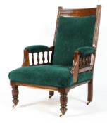 A Victorian mahogany framed armchair, with spindle armrests,