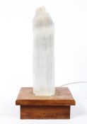 A retro quartz lamp, mounted on wooden plinth base, fitted for electricity,