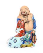 A Chinese porcelain figure of an immortal,