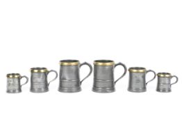 A set of six Victorian W. Martin brass-mounted pewter 'Imperial Measure' tankards